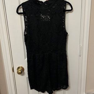 Black lace romper with cutout back. Size Large. New with tags, never worn